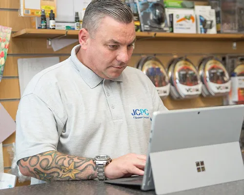 JCPC technician helping with a laptop repair