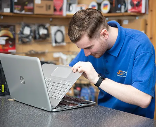 JCPC technician repairing a desktop computer in the shop
